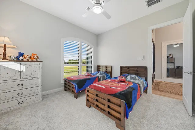 a living room with furniture and a ceiling fan