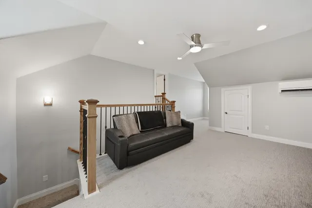 a living room with furniture and white walls