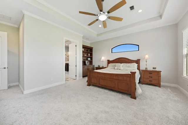 a spacious bedroom with a bed and a large window