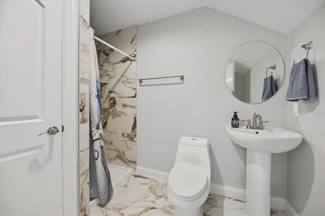 a view of an ocean with a floor to ceiling window and an ocean view