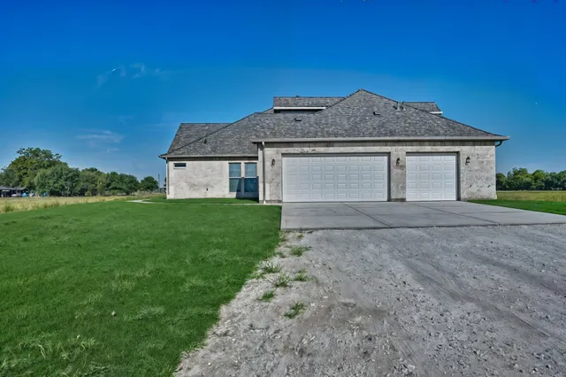 a bathroom with a granite countertop toilet sink and mirror