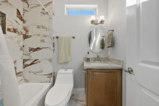 a picture of a bathroom with a shower