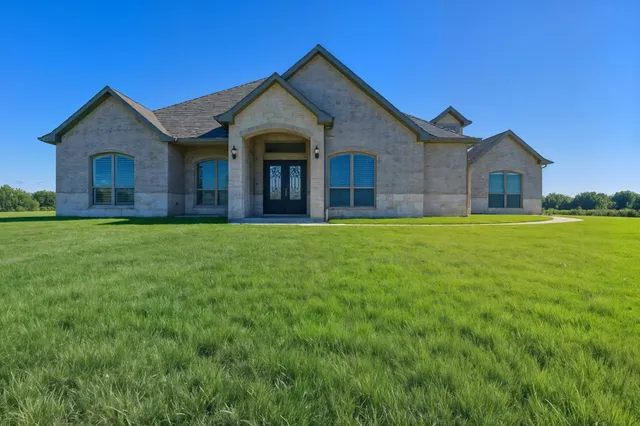 a view of a hallway with wooden floor and a chandelier