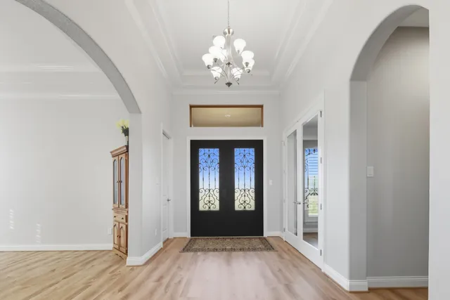 a view of a livingroom with wooden floor and furniture