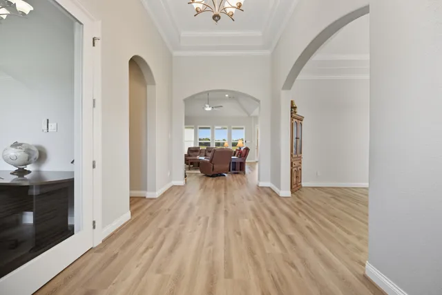 a view of a dining room with furniture wooden floor and chandelier
