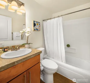 a bathroom with a sink toilet and shower