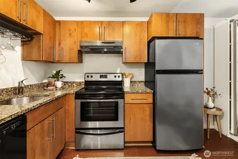a kitchen with a refrigerator and a sink
