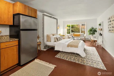 a bedroom with a bed a couch and a window