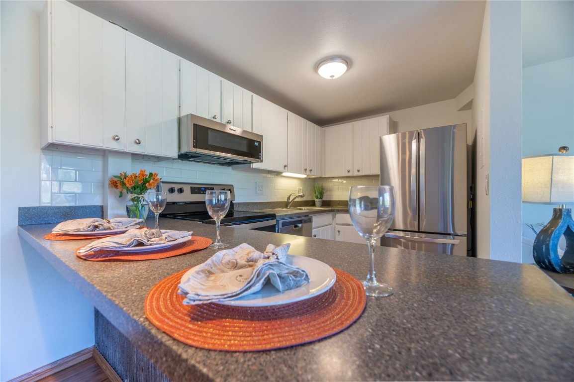 110 Evergreen Road, Unit 102 Dillon, CO 80435 - Photo 21 of 30 a dining room with furniture a kitchen island and appliances
