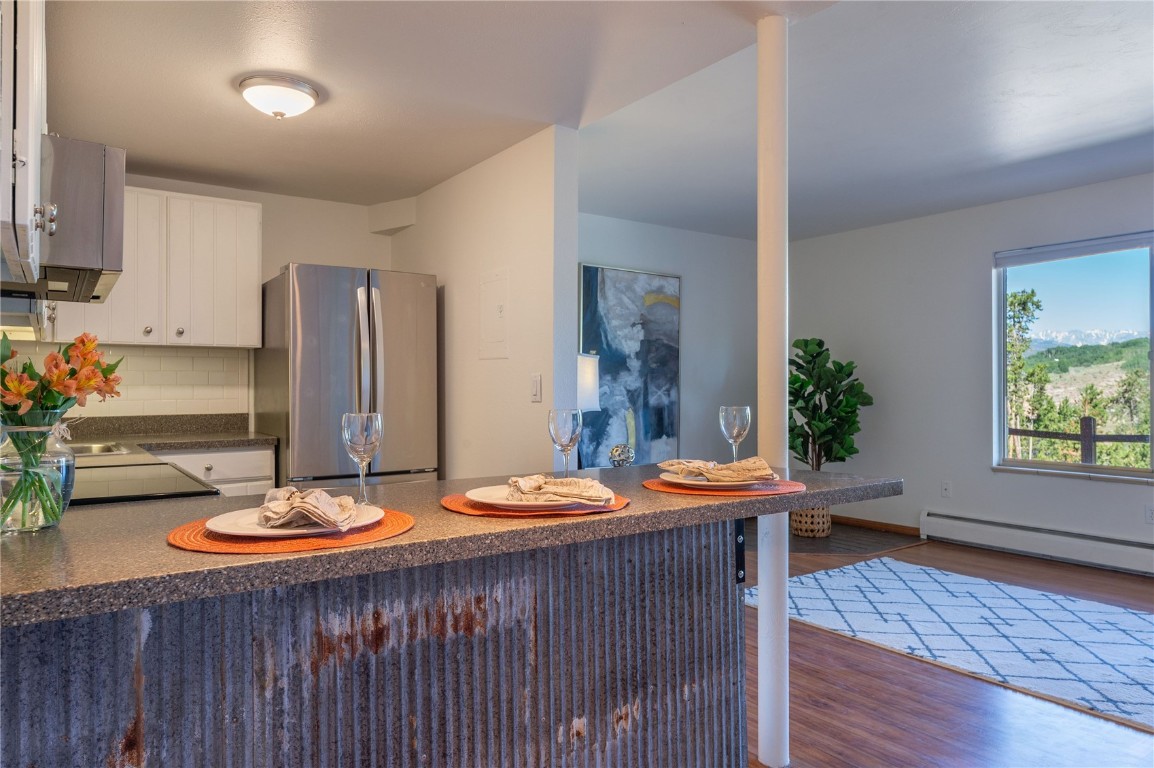 110 Evergreen Road, Unit 102 Dillon, CO 80435 - Photo 5 of 30 a outdoor dining room with furniture and a wooden floor