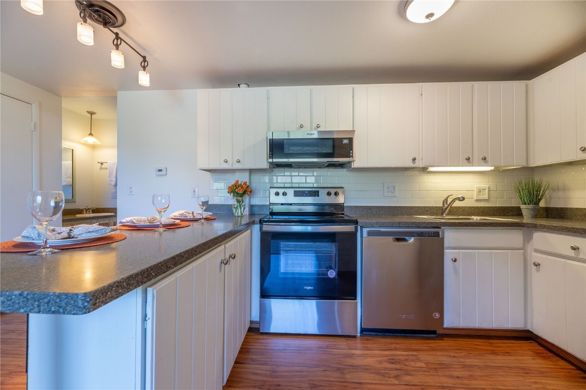 110 Evergreen Road, Unit 102 Dillon, CO 80435 - Photo 6 of 30 a kitchen with a sink stove and cabinets