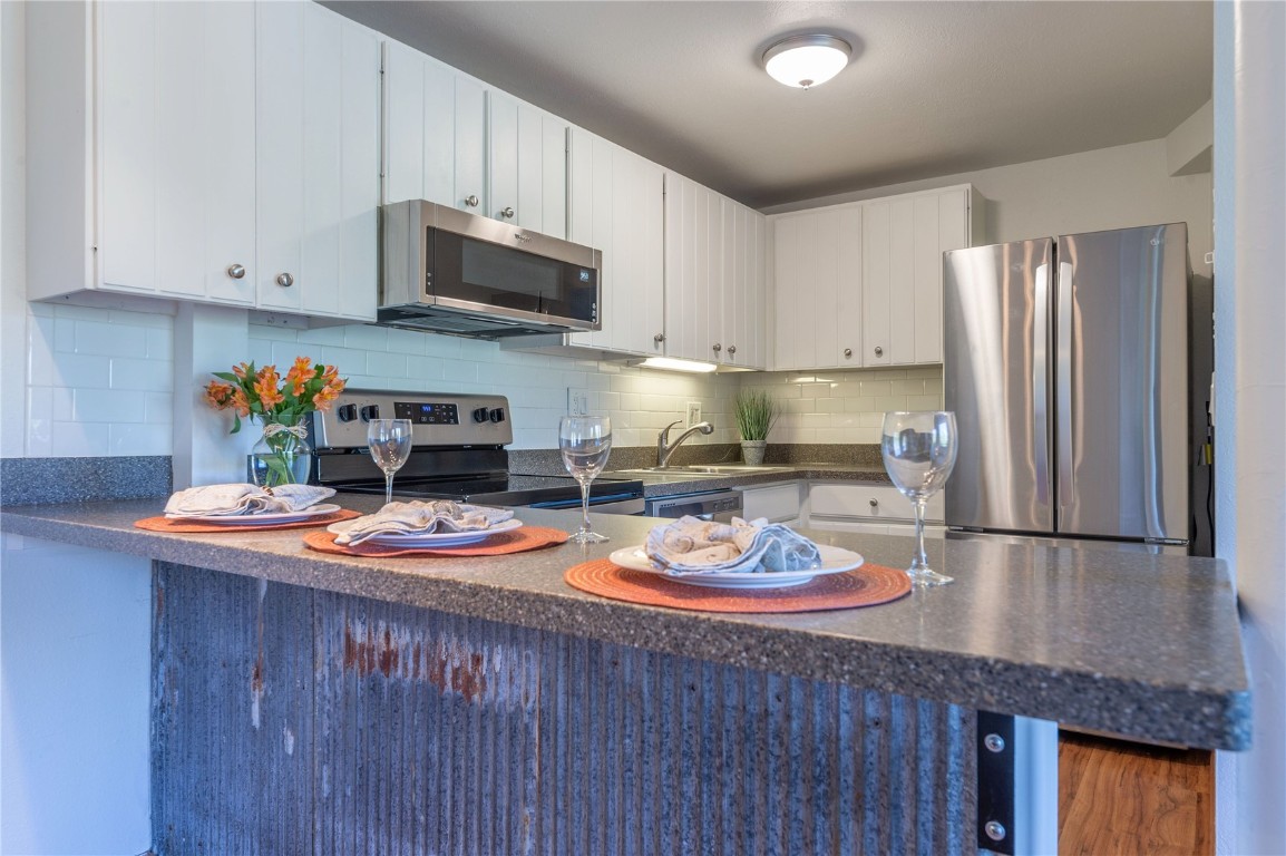 110 Evergreen Road, Unit 102 Dillon, CO 80435 - Photo 7 of 30 a kitchen with a sink a stove and chairs
