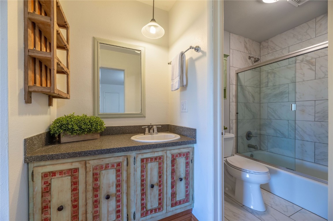 110 Evergreen Road, Unit 102 Dillon, CO 80435 - Photo 9 of 30 a bathroom with a granite countertop sink toilet a mirror and shower