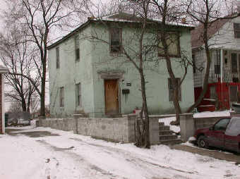a street view with a building in snow