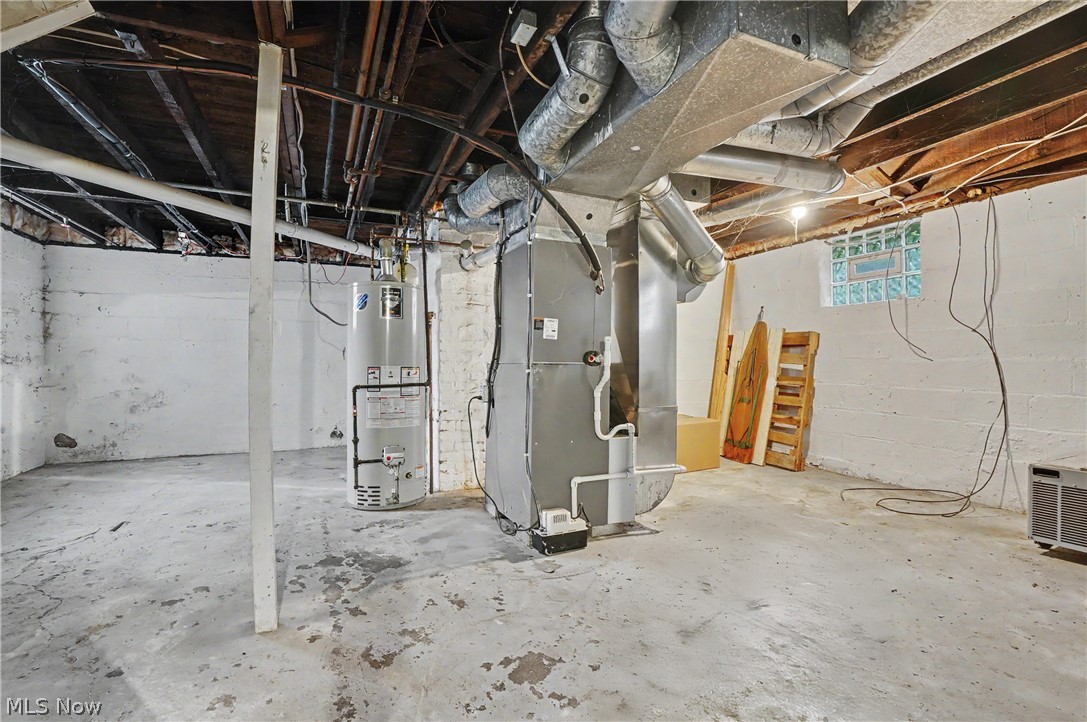 456 Delmar Avenue Akron, OH 44310 - Photo 27 of 27 Spacious basement featuring a water heater, furnace, and exposed ceiling joists