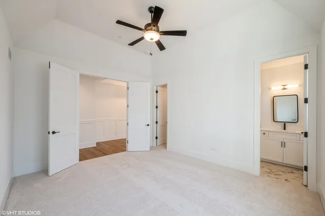 a view of a room with a ceiling fan