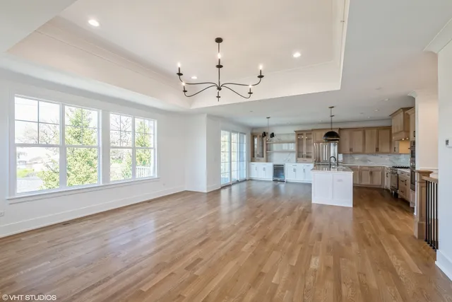 a view of a kitchen and dining room with wooden floor