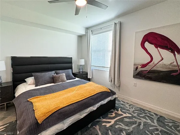 a bed sitting in a bedroom next to a window