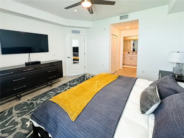 a bedroom with a bed and a flat screen tv