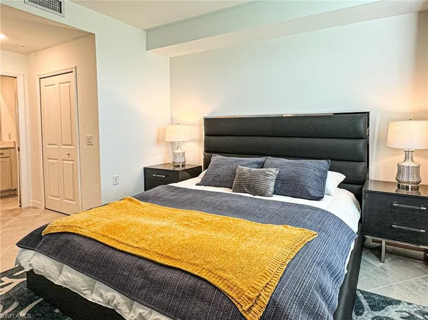 a bedroom with a bed and chair