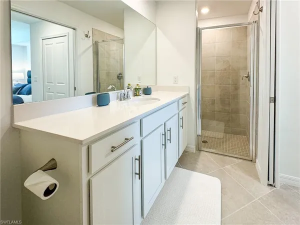 a bathroom with a shower sink and mirror