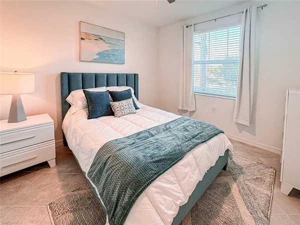 a bedroom with a bed and a painting on the wall