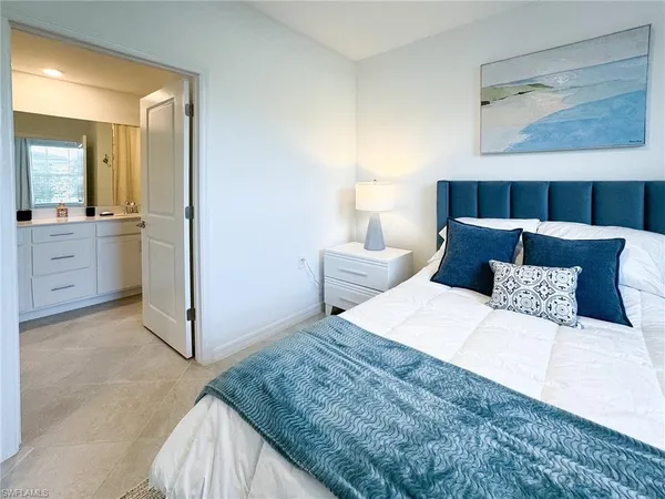 a bedroom with a bed and cabinet