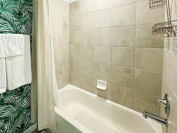 a bathroom with a bathtub and shower