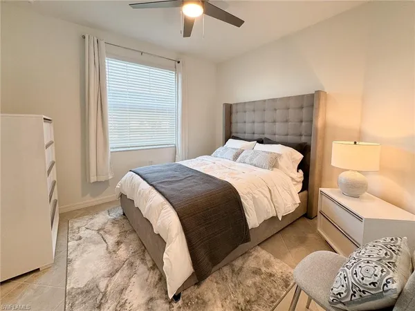 a bedroom with a bed and a couch