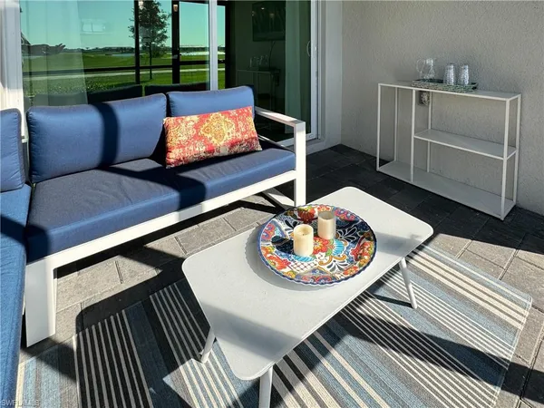 a balcony with furniture and wooden floor