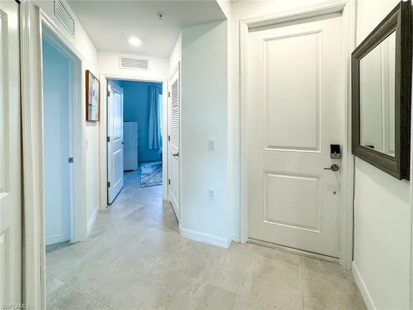 a view of a hallway with closet and wooden floor
