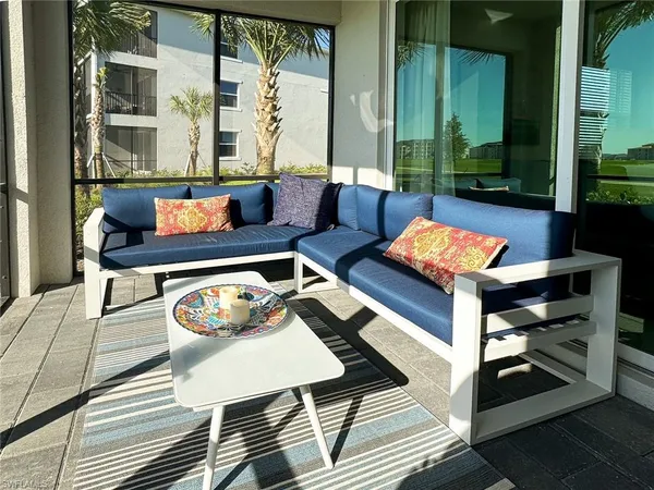 a outdoor living room with furniture and a potted plant