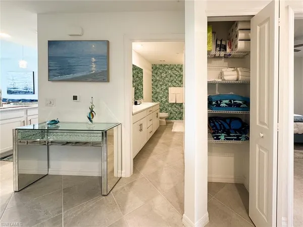 a hallway with a sink and a refrigerator