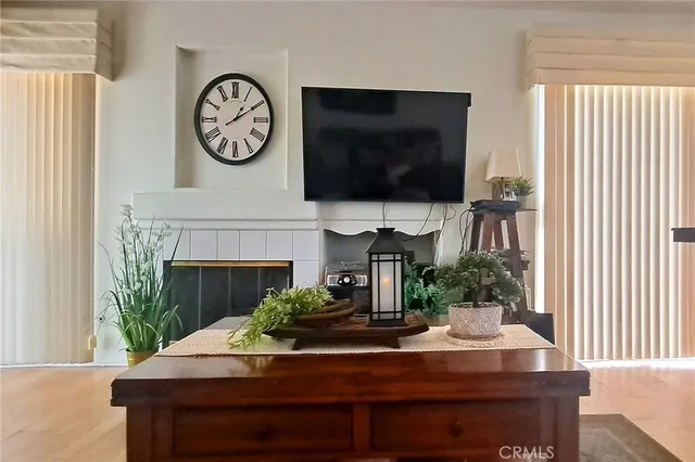 a living room with a flat screen tv and a fireplace