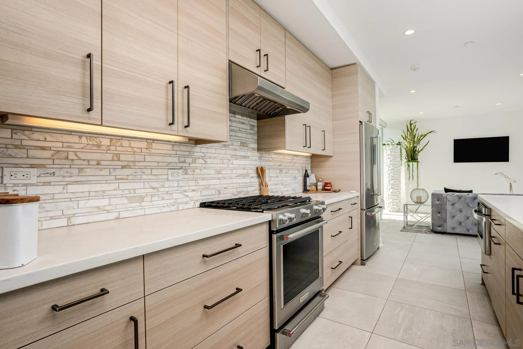 2359 Front Street San Diego, CA 92101 - Photo 15 of 50 a kitchen with stainless steel appliances granite countertop a sink stove and cabinets