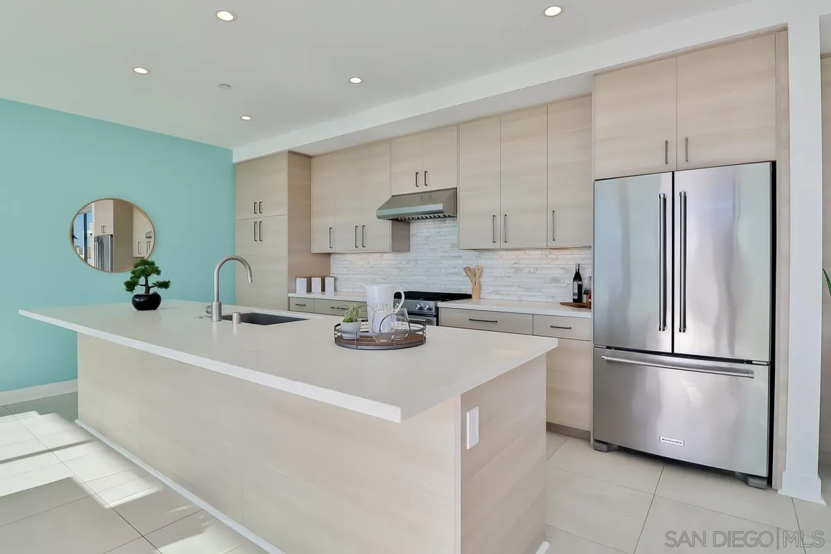 2359 Front Street San Diego, CA 92101 - Photo 16 of 50 a kitchen with a sink a refrigerator and white cabinets