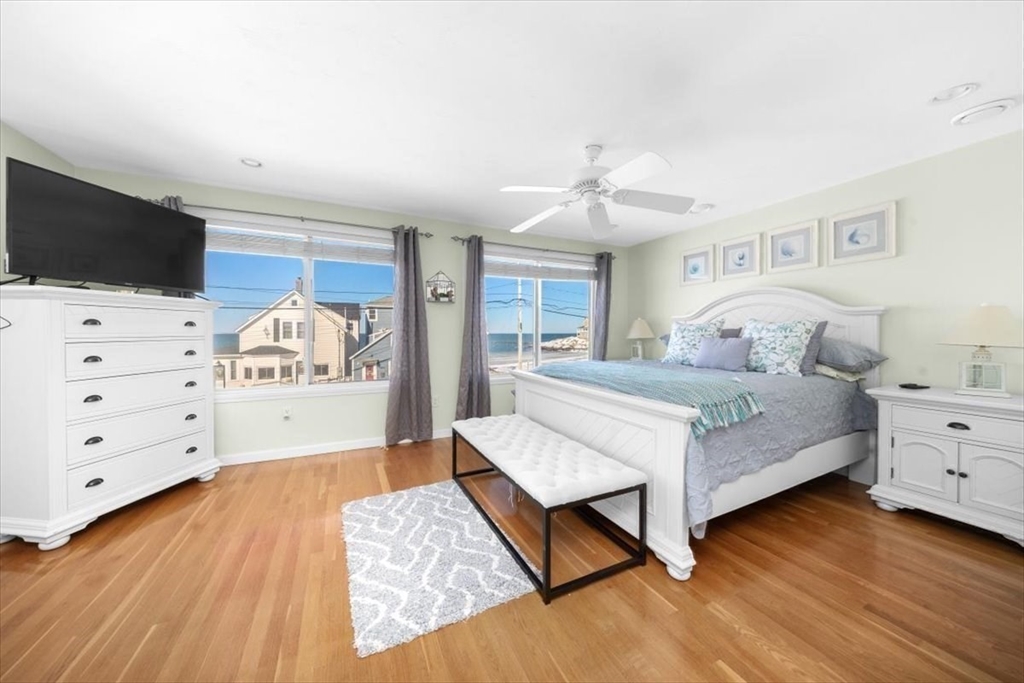 181 Atlantic Avenue Hull, MA 02045 - Photo 14 of 30 a spacious bedroom with a bed and a flat tv screen in it
