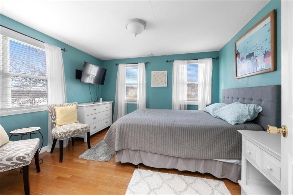 181 Atlantic Avenue Hull, MA 02045 - Photo 18 of 30 a bedroom with a large bed and a flat tv screen