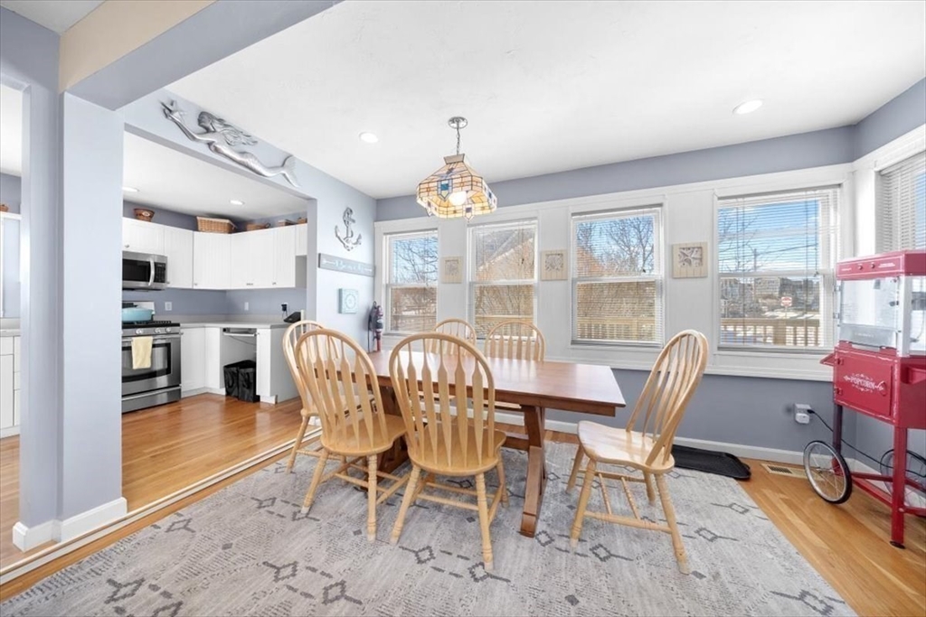 181 Atlantic Avenue Hull, MA 02045 - Photo 9 of 30 a dining room with furniture a rug and a chandelier