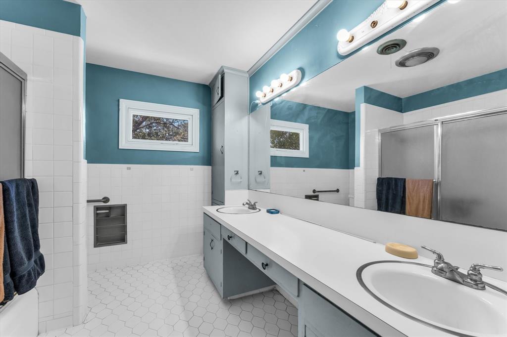 421 Rice Avenue Waco, TX 76708 - Photo 25 of 40 Upstairs Master bathroom dual vanity with integrated sinks, full-width mirror, and overhead strip lighting
