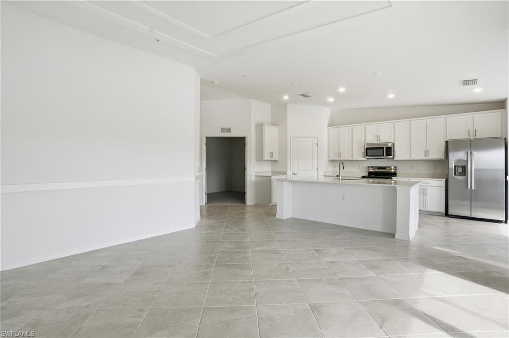 15185 Bluffton Lane, Unit 826 Punta Gorda, FL 33982 - Photo 13 of 50 a kitchen with stainless steel appliances a refrigerator sink and microwave