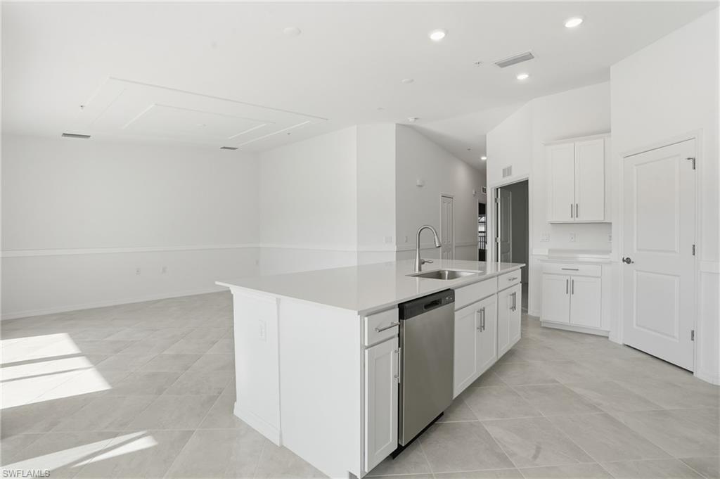 15185 Bluffton Lane, Unit 826 Punta Gorda, FL 33982 - Photo 19 of 50 a kitchen with a sink stove and cabinets