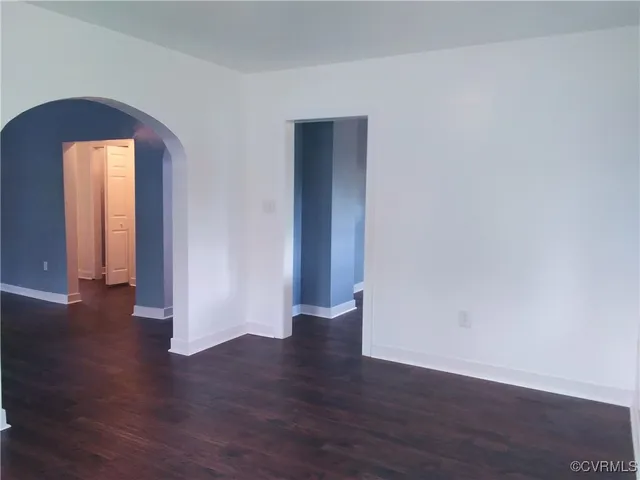 a view of a room with wooden floor