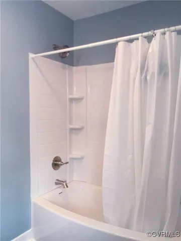 a bathroom with a shower and a sink