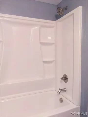 a bathroom with a shower and a sink