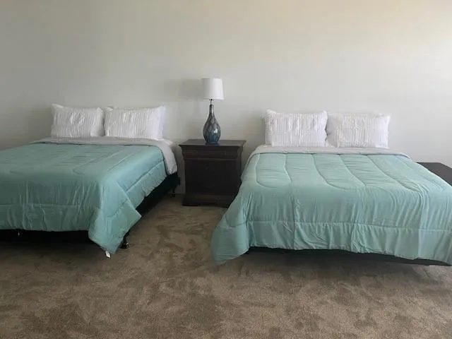 a bedroom with a bed and a night stand