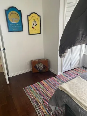 a bedroom with bed and cupboard