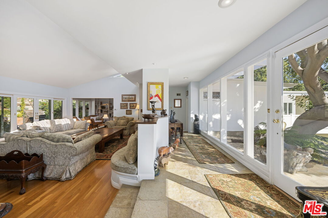 11215 Sunset Boulevard Los Angeles, CA 90049 - Photo 16 of 74 a living room with furniture large window and wooden floor