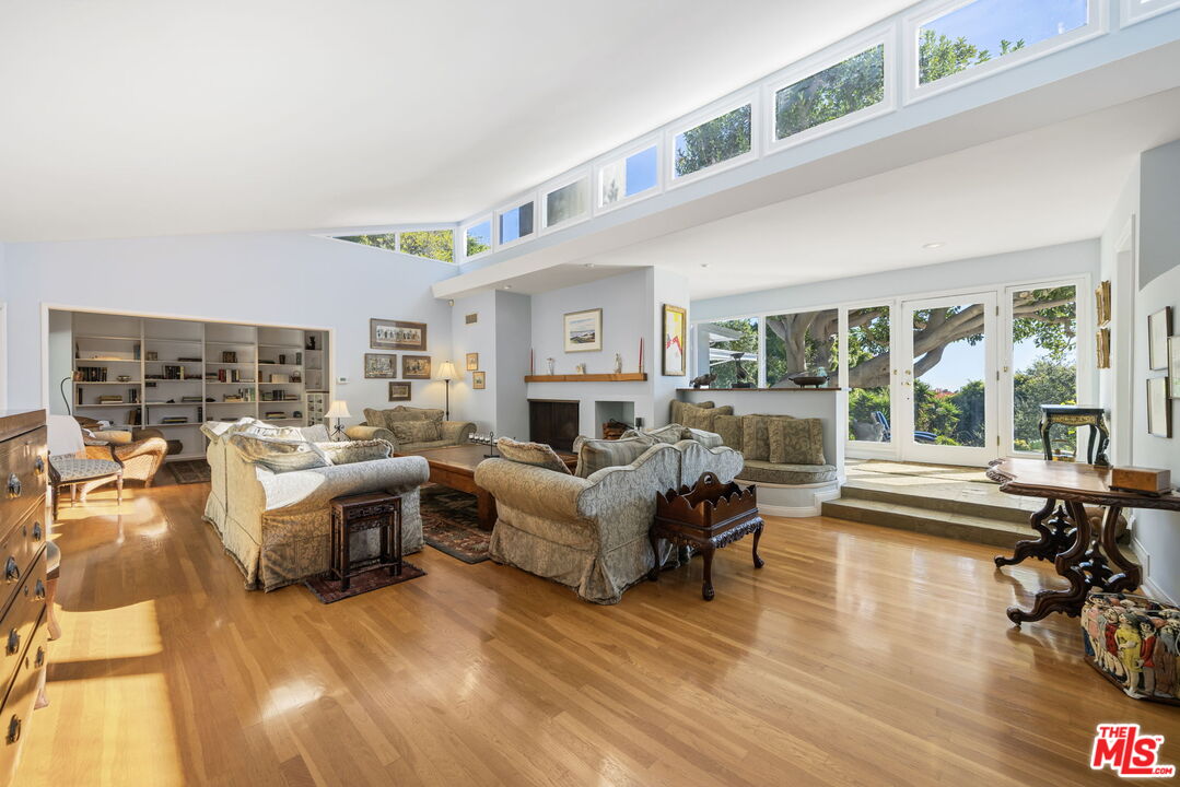 11215 Sunset Boulevard Los Angeles, CA 90049 - Photo 18 of 74 a living room with furniture large window and a fireplace