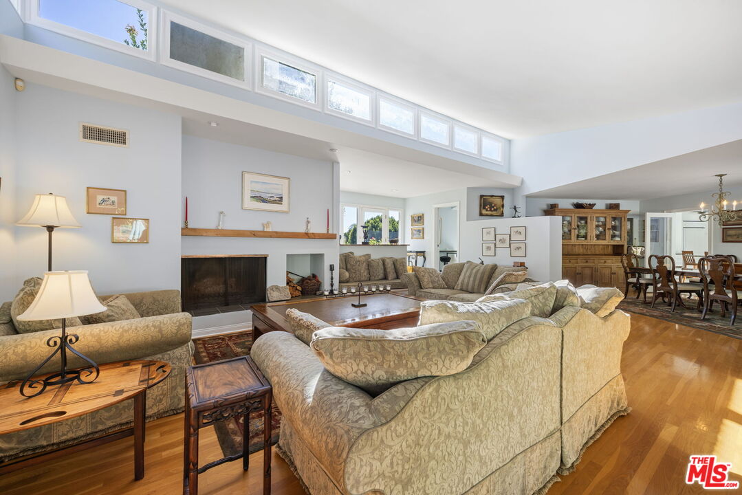 11215 Sunset Boulevard Los Angeles, CA 90049 - Photo 19 of 74 a living room with furniture and a fireplace